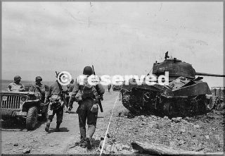 soldiers-of-the-1st-armored-division-u.s.-pass-downed-and-burnt-tank-m4-sherman-in-the-area-of-anzio